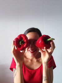 Portrait of woman holding strawberries