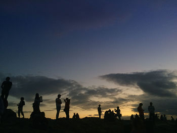 Silhouette people against the sky