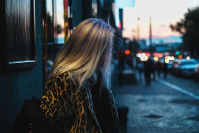 Fashionable woman standing on street in city