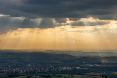 Aerial view of townscape against sky at sunset