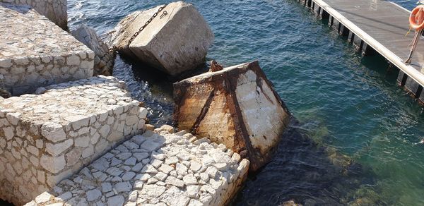 High angle view of stones by sea