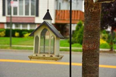 Close-up of birdhouse on street against building