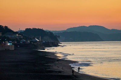 Scenic view of sea against orange sky