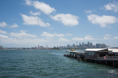 Scenic view of sea by buildings against sky