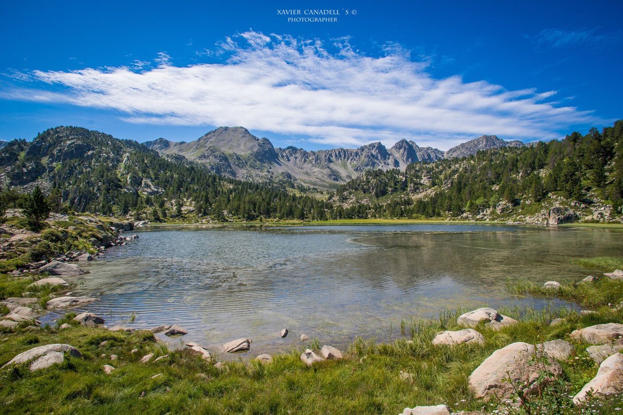 tranquil scene, mountain, water, tranquility, scenics, sky, lake, beauty in nature, nature, tree, mountain range, blue, landscape, idyllic, cloud, non-urban scene, cloud - sky, river, countryside, day