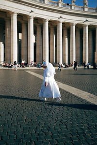 Nun walking on st peters square