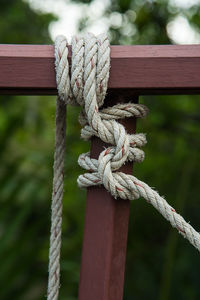 Close-up of rope tied on railing