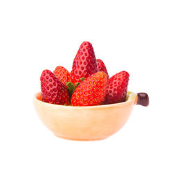 Close-up of strawberries in bowl against white background