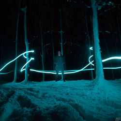 Light trails on snow covered land at night