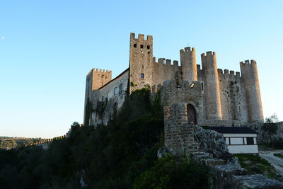 Low angle view of fort against clear sky