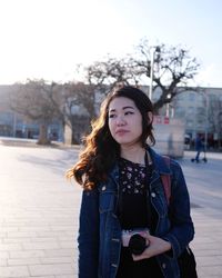 Portrait of woman standing in city during winter