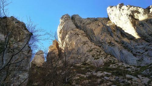 Low angle view of rock formation against sky