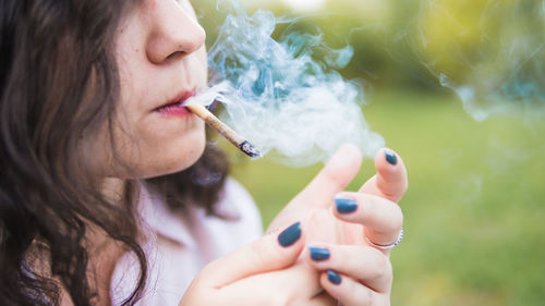 Midsection of woman holding cigarette