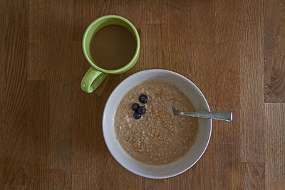 Close-up high angle view of coffee cup on wooden table