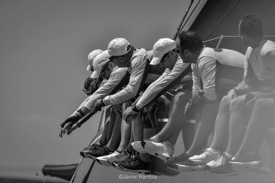 People in boat against sky