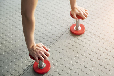 Close-up of hand balancing on dumbbells