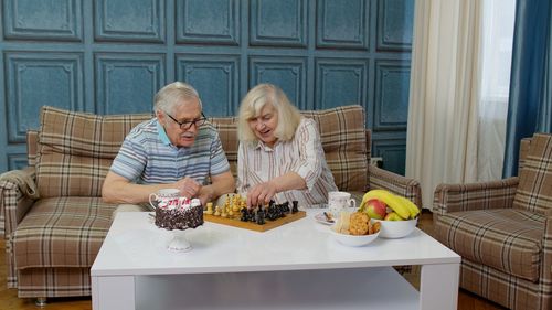 Portrait of senior man with daughter at home