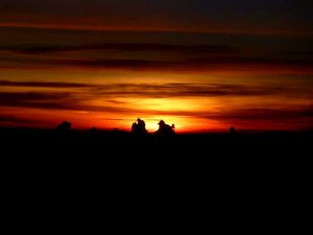 Scenic view of silhouette landscape against sky during sunset