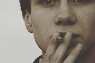 Close-up of young man smoking cigarette