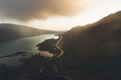 Scenic view of sea and mountains against sky