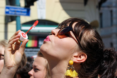 Portrait of woman holding sunglasses