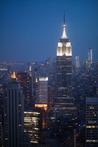 High angle view of buildings lit up at night