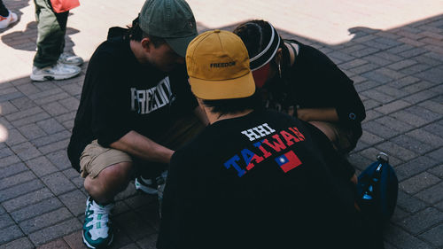 High angle view of people sitting on street