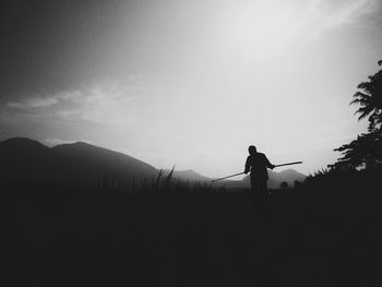 Silhouette of man standing on landscape