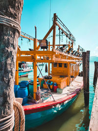 Ship moored at harbor against clear sky