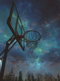 Low angle view of basketball hoop against stars in sky at night