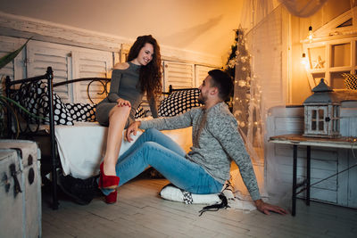 Full length of woman sitting on floor