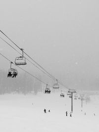 Overhead cable cars on snow covered landscape