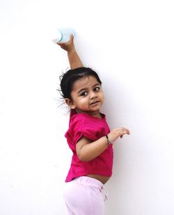 Portrait of girl against pink wall