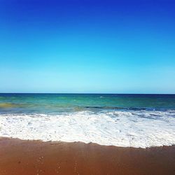 Scenic view of sea against clear blue sky