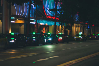 Illuminated city street at night