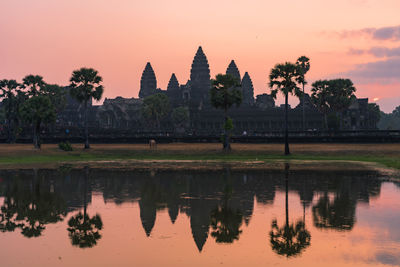 Reflection of temple in lake at sunset