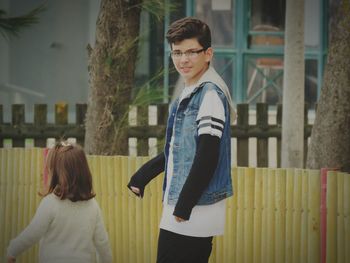 Brother and sister walking outdoors