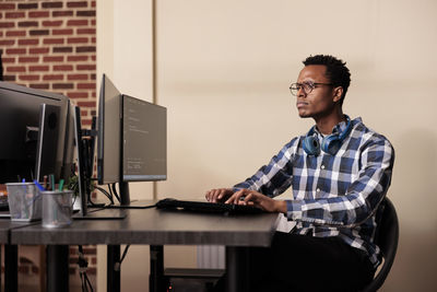 Young man using laptop at office