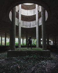 Woman standing in abandoned building