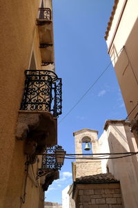 Low angle view of buildings against blue sky