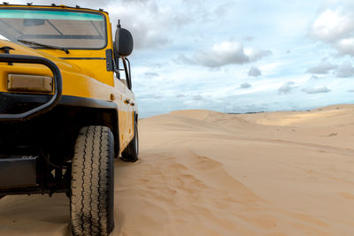 Truck in desert against sky