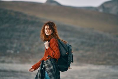 Portrait of smiling young woman standing outdoors