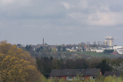 High angle view of trees and buildings against sky