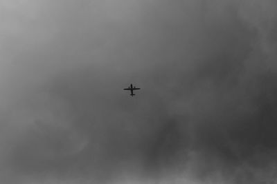 Low angle view of airplane flying in sky