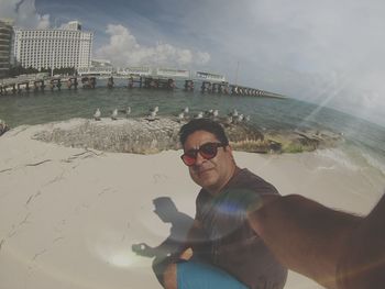 Portrait of man in sunglasses against sky