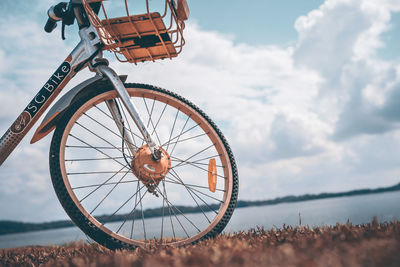 Low angle view of bicycle wheel on field