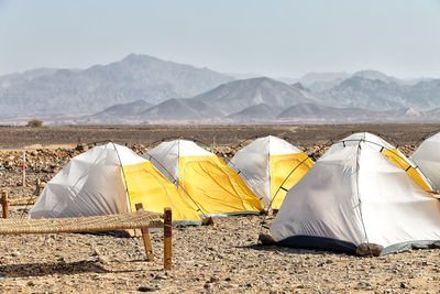Tent on land against mountain range against sky