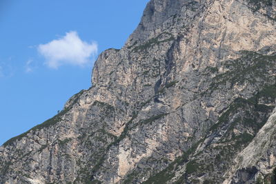 Low angle view of rocky mountain against sky