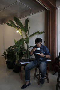 Man sitting on chair at home