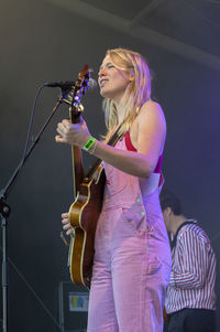 Young woman with arms raised